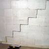 A diagonal stair step crack along the foundation wall of a Cadillac home