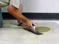 Repairing the cored holes in the concrete slab floor with fresh concrete and cleaning up the Mount Pleasant home.