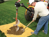 Auguring a hole in the earth for a foundation wall repair system in Mount Pleasant