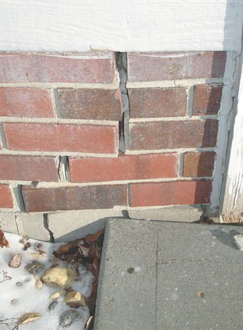 Severe street creep damage to a garage wall outside a Boyne City home