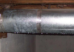 condensation collecting on an HVAC vent in a humid Niles basement
